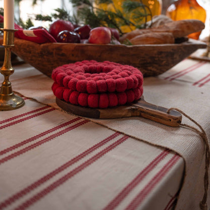 Närbild av julduken Hedvig med röda ränder på ett stämningsfullt dukat julbord