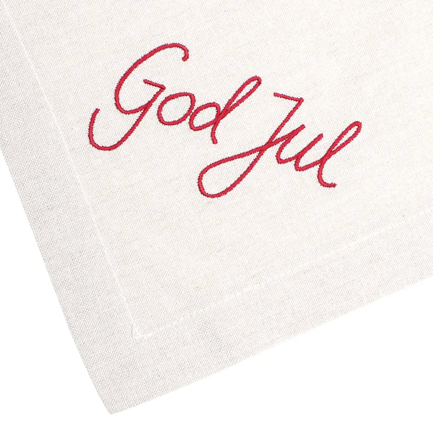 Broderad röd God Jul-text på linnefärgad julservett