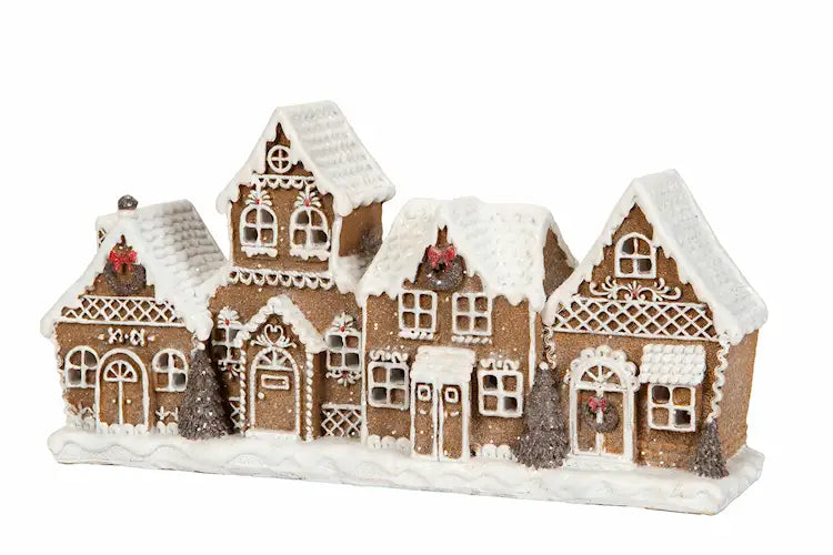 LED-lykta med fyra sammanbyggda pepparkakshus, snötäckta tak och vita dekorativa detaljer, 25 cm bred.